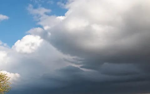 Dark storm cloud building over the hills, the kind that can bring hail in spring